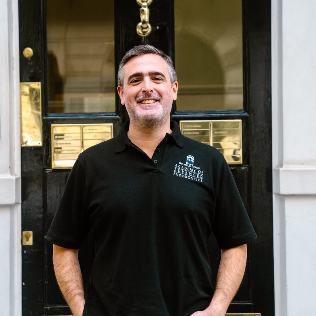 Clinical director, David Selouk, standing outside of the dental practice in London