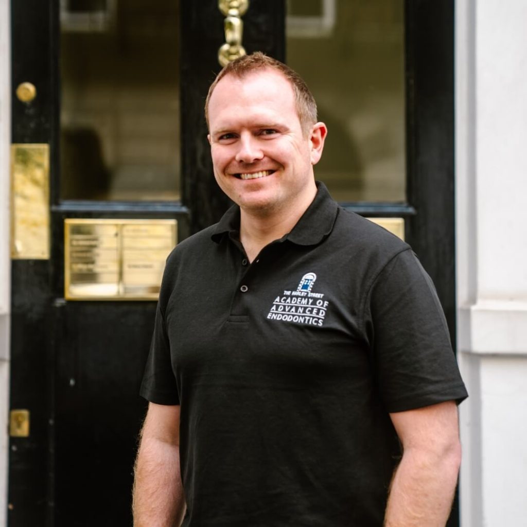 Specialist in endodontics, Ian Blewitt, standing outside of the dental practice in London