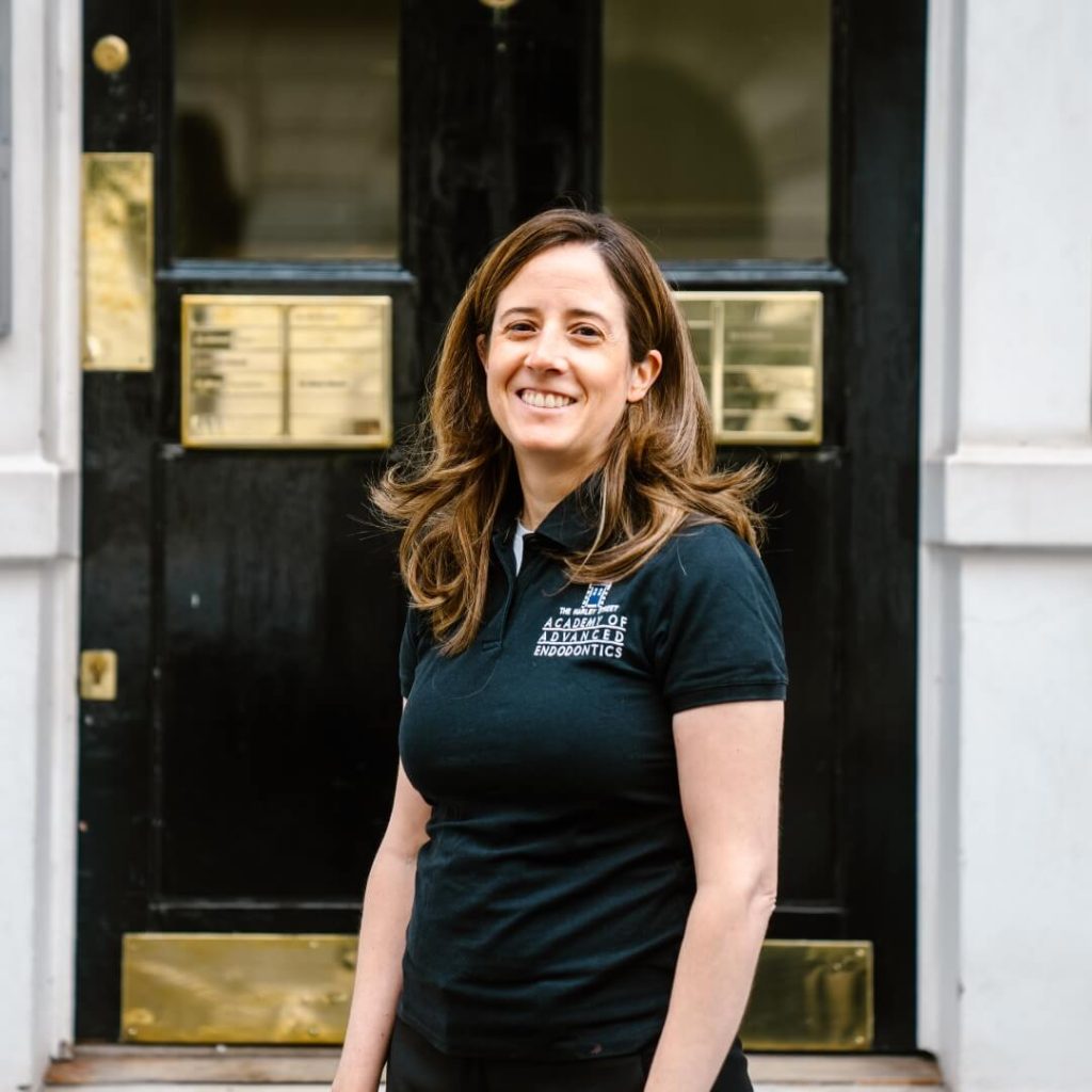 Endodontic Masters Graduate, Irene Soriano, standing outside of the dental practice in London