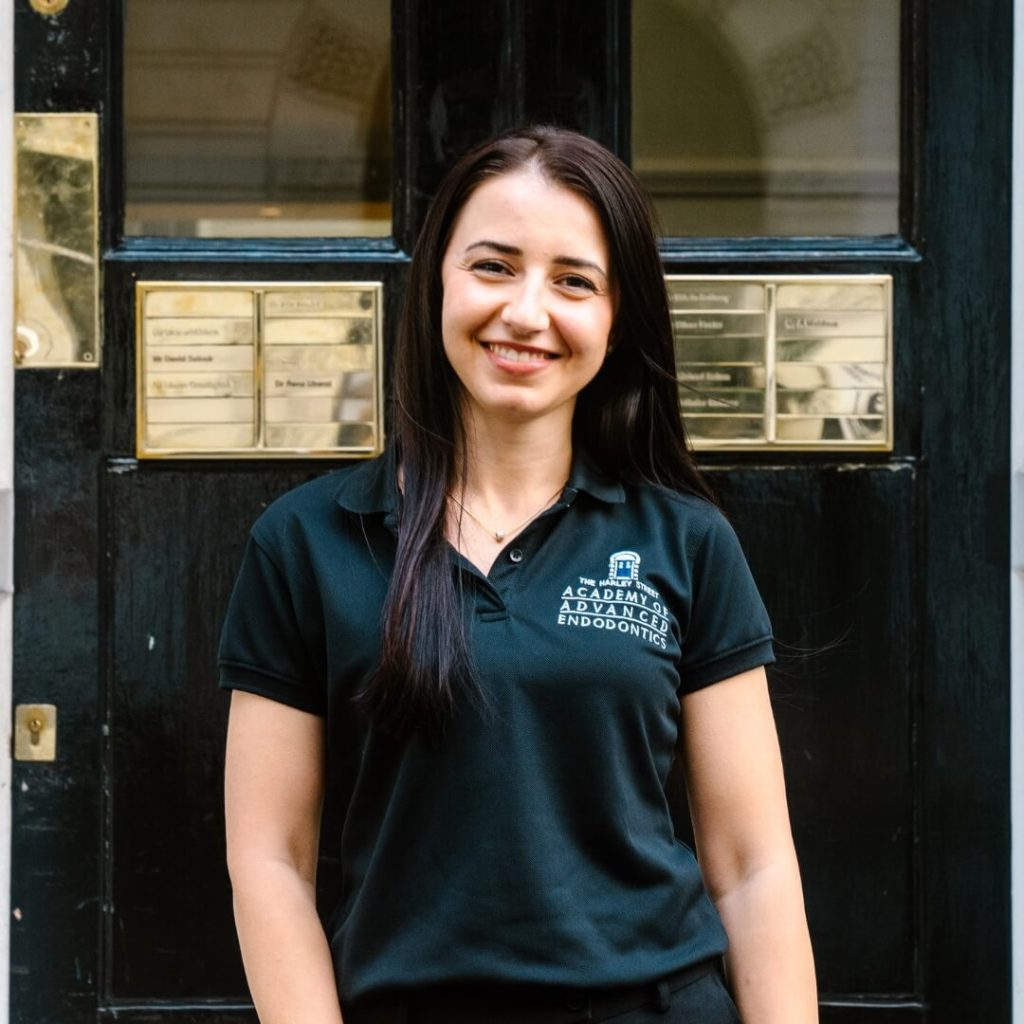 Specialist Endodontic Nurse, Natalia Ponici, standing outside of the dental practice in London