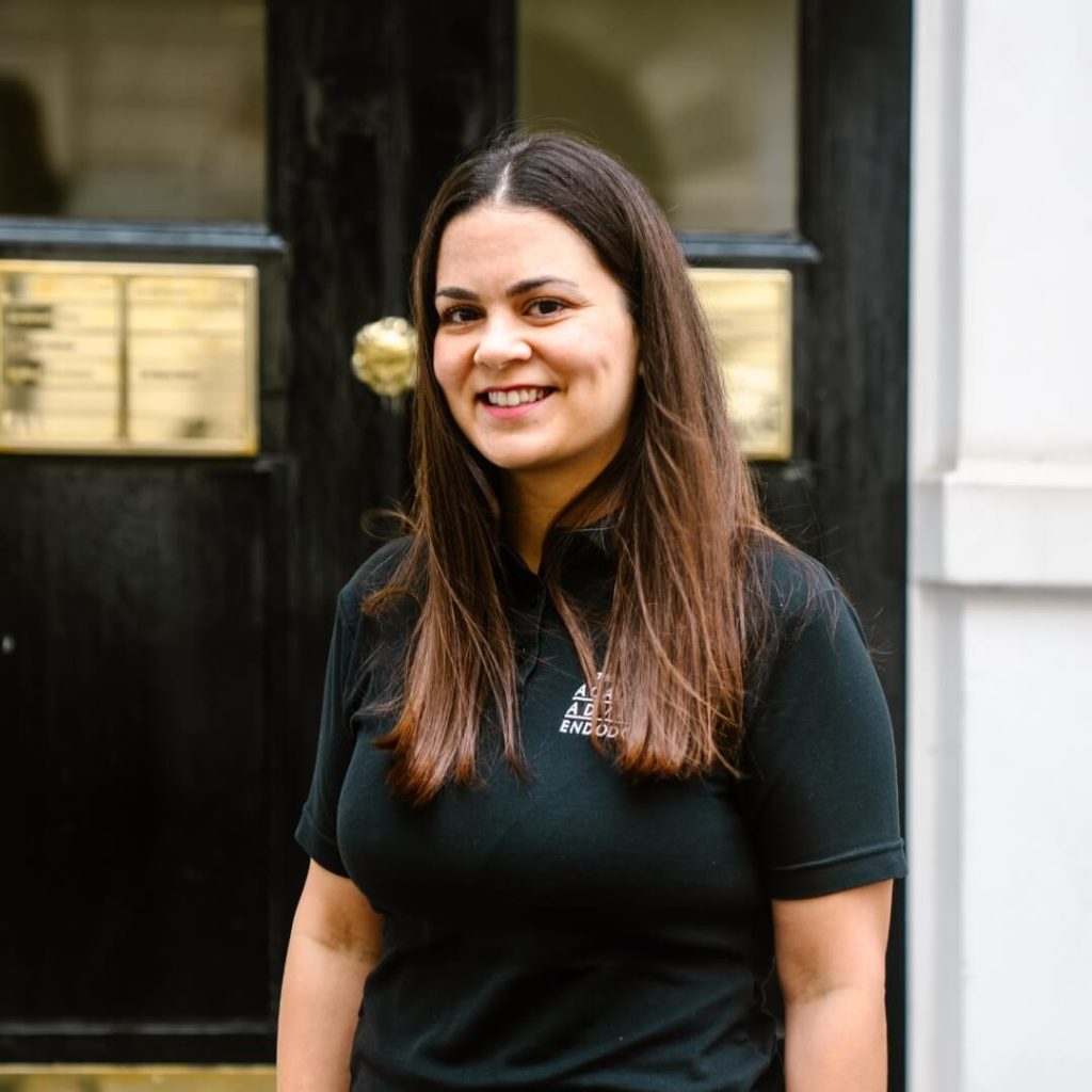 Endodontic Masters Graduate, Stella Sarafi, standing outside of the dental practice in London