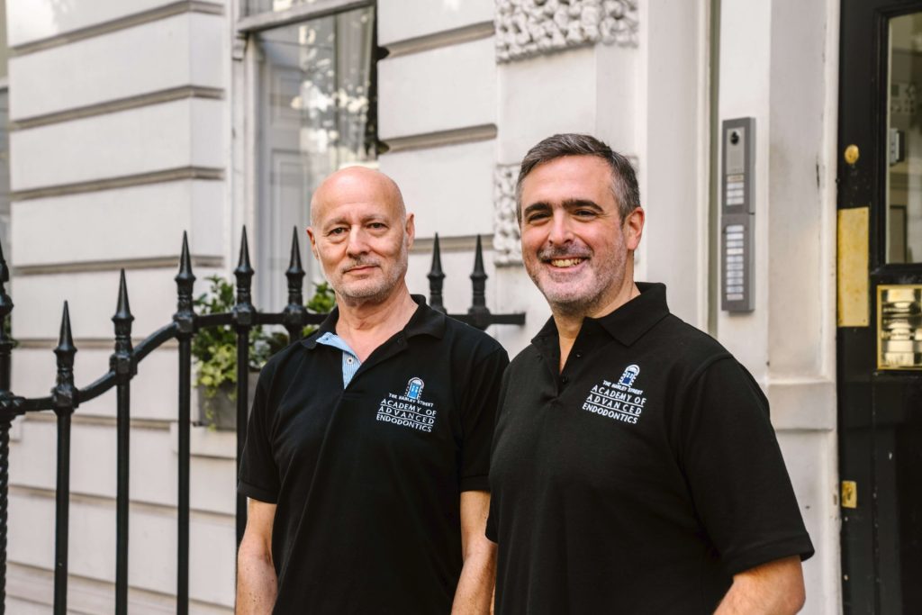 Clinical directors Richard Kahan anad David Selouk posing for a photo outside of their practice in London on the doorstep. Both in matching black uniform