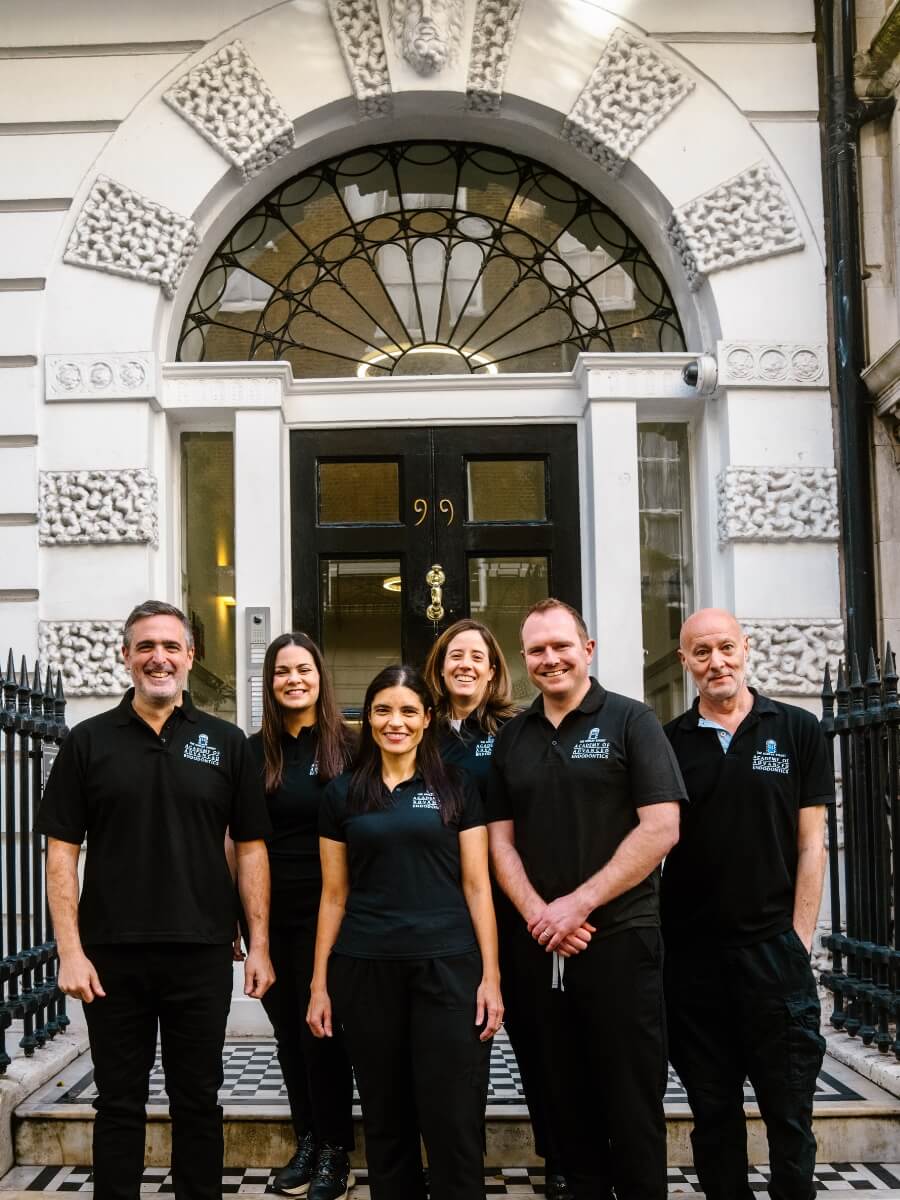 Team members of the Academy of Advanced Endodontics standing outside of their practice in London. From left to right- David Selouk, Stella Sarafi, Leigh-Ann Elias, Irene Soriano, Ian Blewitt, Richard Kahan